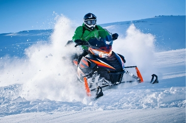 Snowmobile riding through deep powder